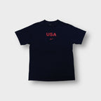 Nike T-Shirt in navy featuring red USA graphic print and swoosh logo