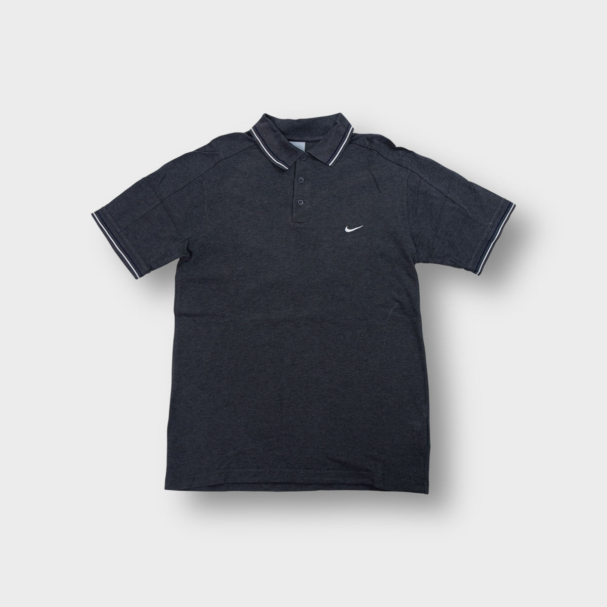 Nike polo shirt in charcoal grey with white embroidered swoosh and tipped collar