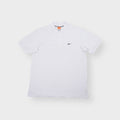 Nike short sleeve polo shirt in white featuring a small black swoosh logo embroidered on the chest