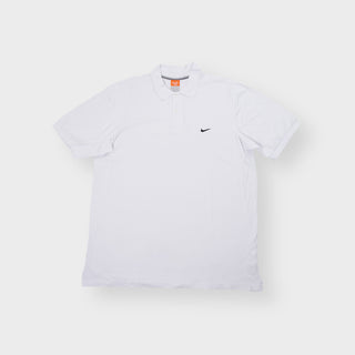 Nike short sleeve polo shirt in white featuring a small black swoosh logo embroidered on the chest