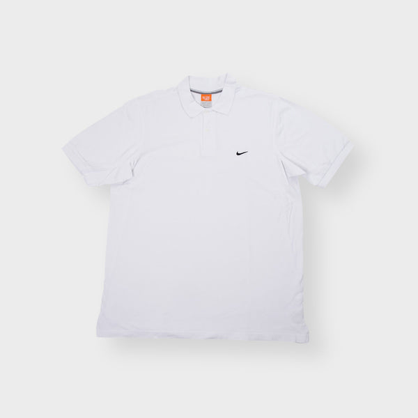 Nike short sleeve polo shirt in white featuring a small black swoosh logo embroidered on the chest