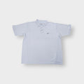 Light blue Nike polo shirt featuring a dark embroidered swoosh on the left chest