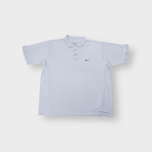 Light blue Nike polo shirt featuring a dark embroidered swoosh on the left chest