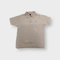 Beige Nike waffle-knit half-zip polo shirt with embroidered script logo