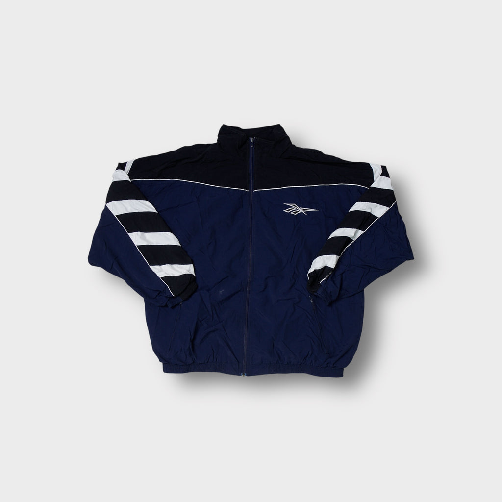 Reebok track jacket in navy blue with diagonal white and black sleeve stripes