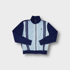 Puma track jacket in navy blue with light blue vertical striped front panel.