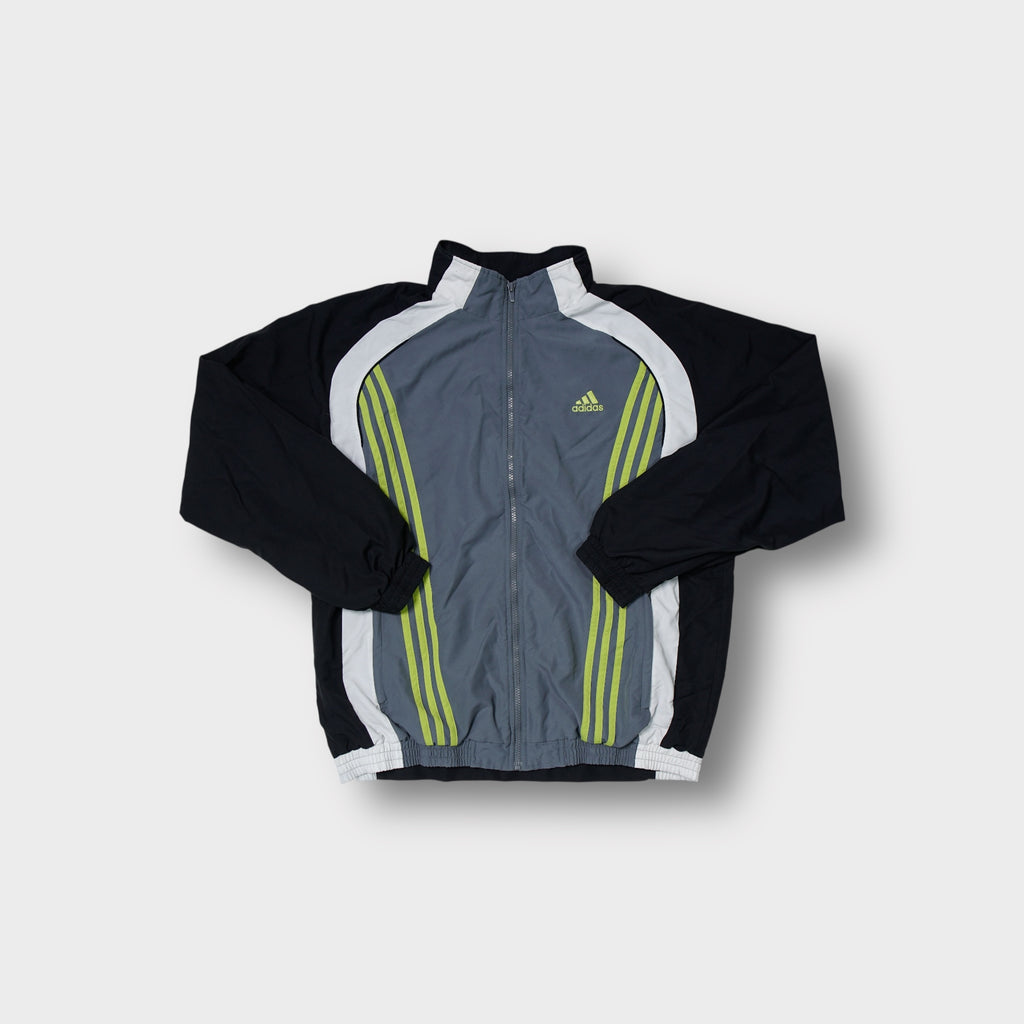 Adidas track jacket in grey and black with yellow three-stripe chest embroidery.