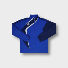 Lade das Bild in den Galerie-Viewer, Adidas zip track jacket in blue with diagonal white paneling and embroidered logo.
