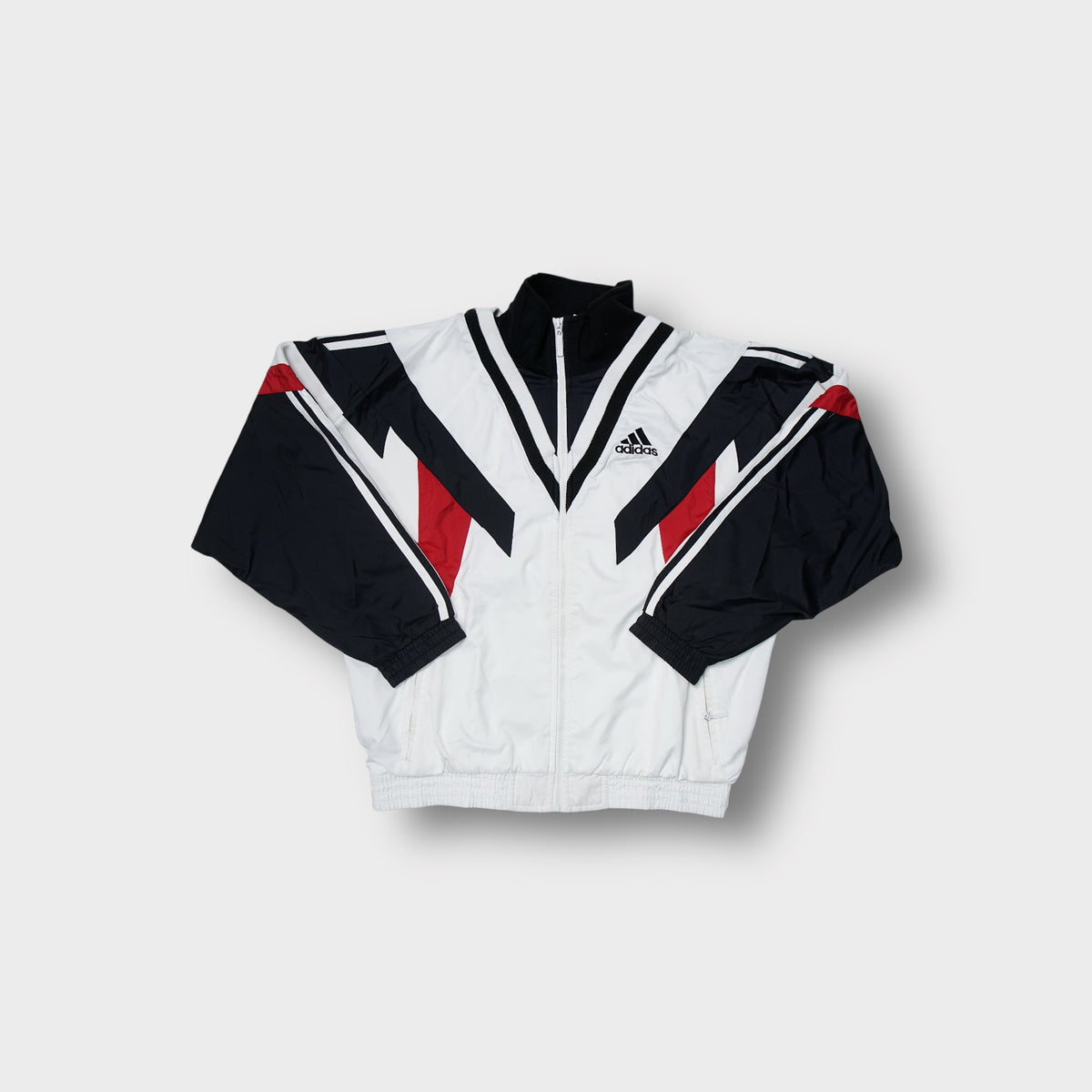 Adidas track jacket in white, black, and red with geometric panelling