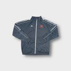 Gray Adidas track jacket with white sleeve stripes and red embroidered NEM chest logo