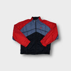 Nike track jacket in red, blue, and black with a chevron pattern and embroidered logo