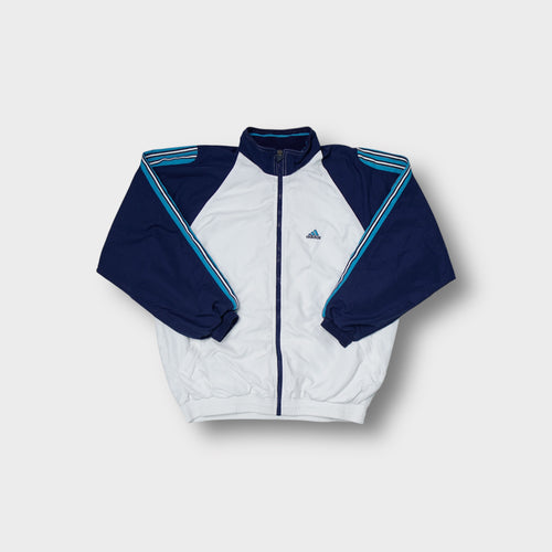 Adidas track jacket in white and navy with blue stripe details on the sleeves.