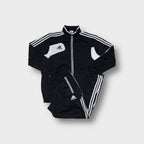 Adidas tracksuit set in black and white featuring contrast panel details
