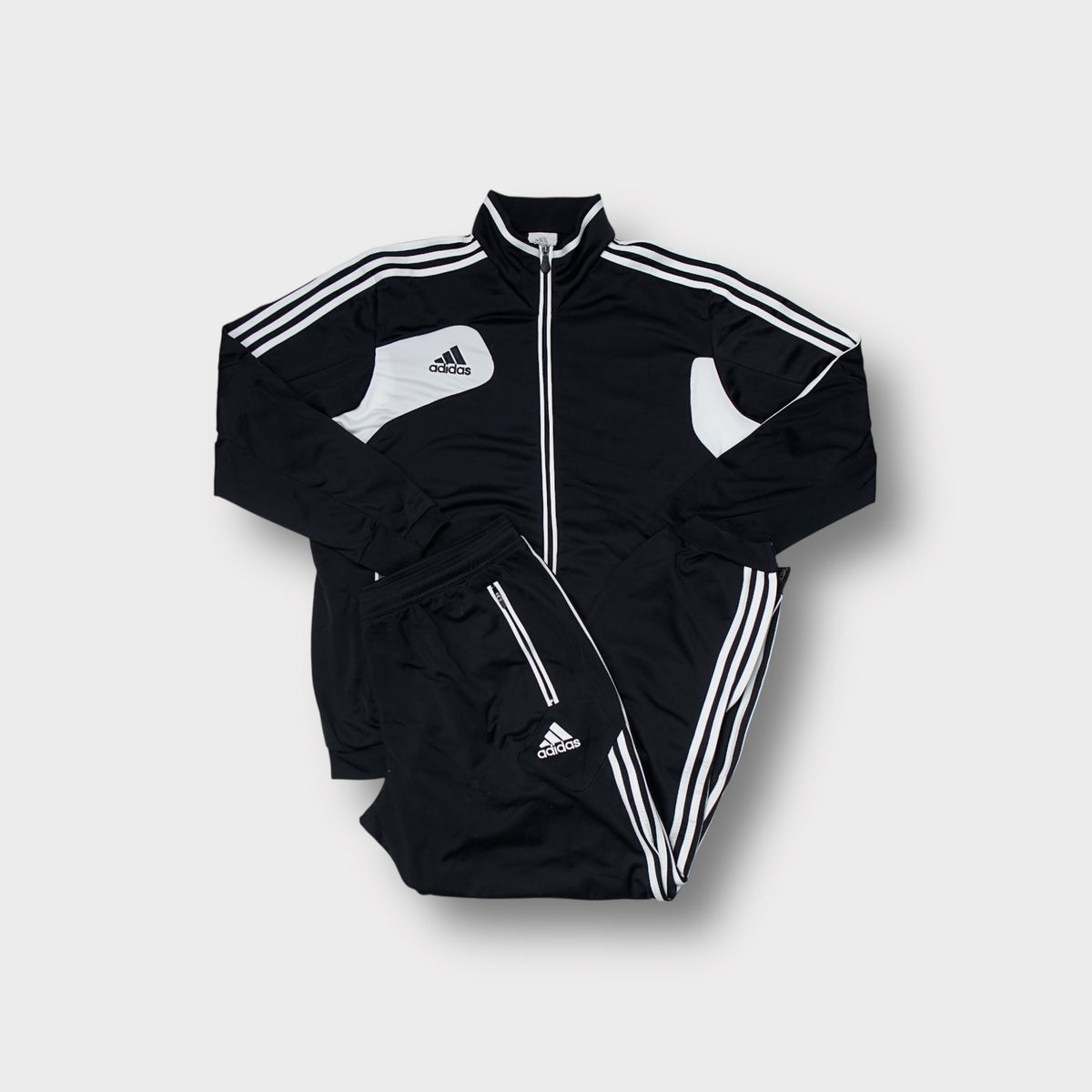 Adidas tracksuit set in black and white featuring contrast panel details