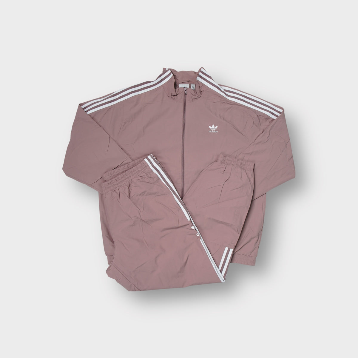 Adidas tracksuit in mauve with white three-stripe detailing and trefoil logo