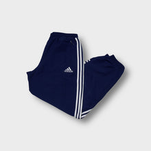 Lade das Bild in den Galerie-Viewer, Adidas track pants in navy blue featuring white three stripes and an embroidered logo.
