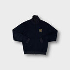Adidas track jacket in navy featuring a gold embroidered tennis laurel crest