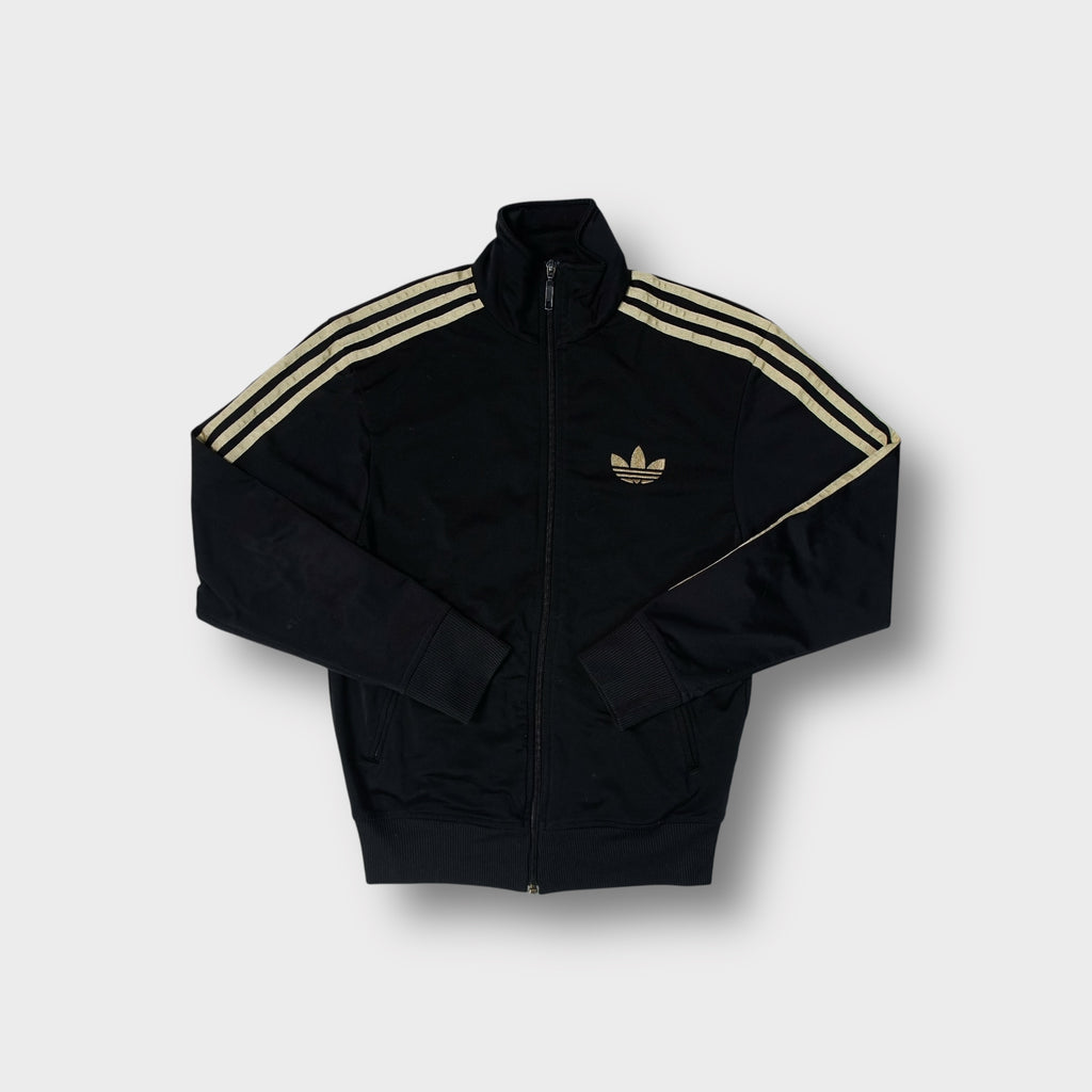 Adidas track jacket in black with metallic gold embroidered trefoil logo and sleeve stripes