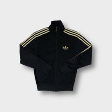 Load image into Gallery viewer, Adidas track jacket in black with metallic gold embroidered trefoil logo and sleeve stripes