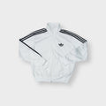Adidas track jacket in white and black with embroidered trefoil logo and three stripes