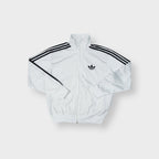 Adidas track jacket in white and black with embroidered trefoil logo and three stripes