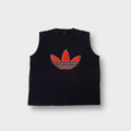 Adidas jacket in black featuring a large red embroidered Trefoil logo on the front chest