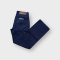 Psycho International navy workwear pants with side utility pocket and brown leather back patch.