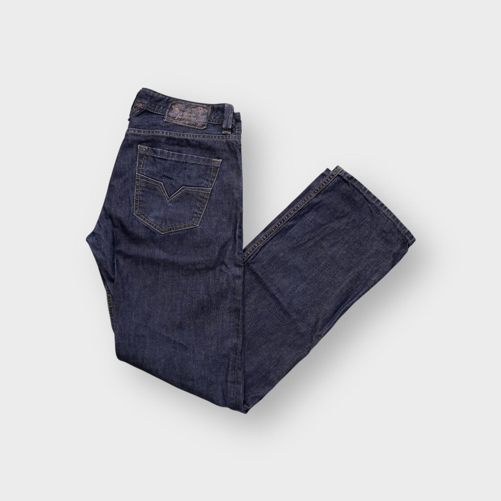 Diesel jeans in dark blue denim showing signature V-stitching on the back pocket