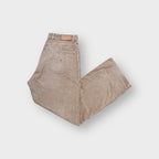 Tommy Hilfiger beige corduroy pants featuring an embroidered flag logo on the back pocket