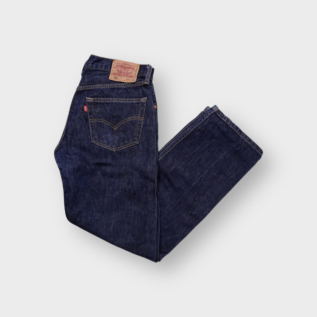 Levi's 501 jeans in dark indigo denim with signature leather patch on waist