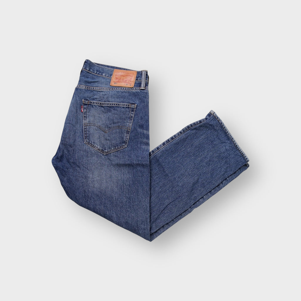 Levi's blue denim jeans featuring a tan leather back patch and copper rivets