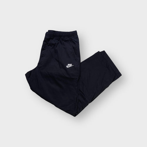 Nike trackpants in black featuring a white embroidered Futura logo on the thigh
