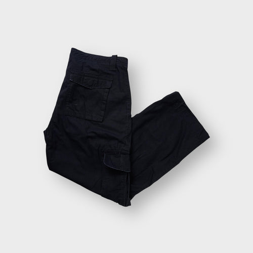 Black Nike cargo trousers featuring flap utility pockets on both side legs