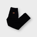 Wrangler denim jeans in black featuring a brown leather logo patch on the back pocket