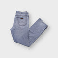 Wrangler light blue denim jeans with W-shaped back pocket stitching and leather patch