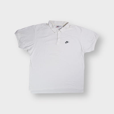 Nike polo shirt in white featuring a small black embroidered swoosh logo on chest