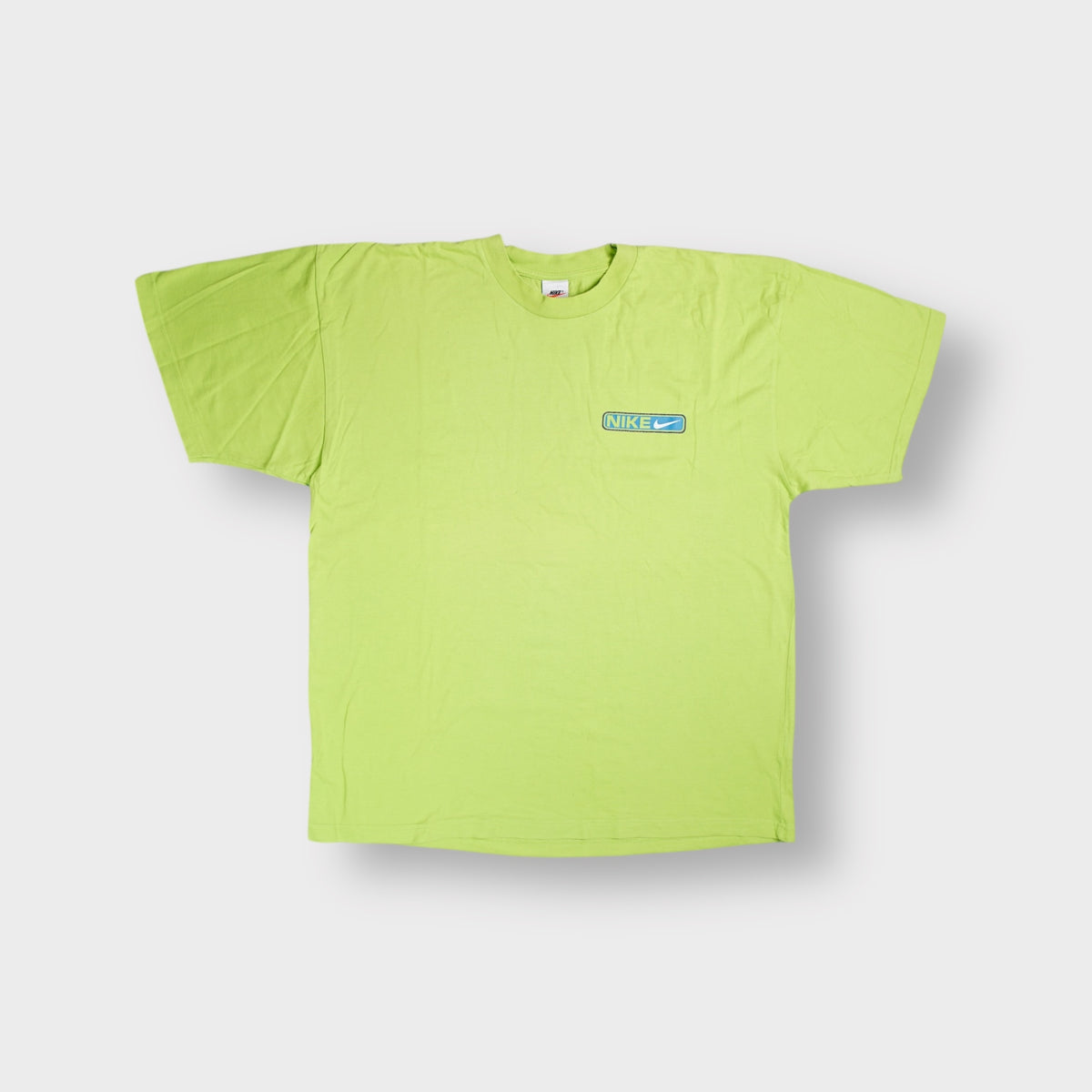 Bright green Nike T-Shirt displaying a blue Nike Air chest graphic.