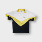 Nike shirt in white and yellow featuring a chevron pattern and small chest swoosh