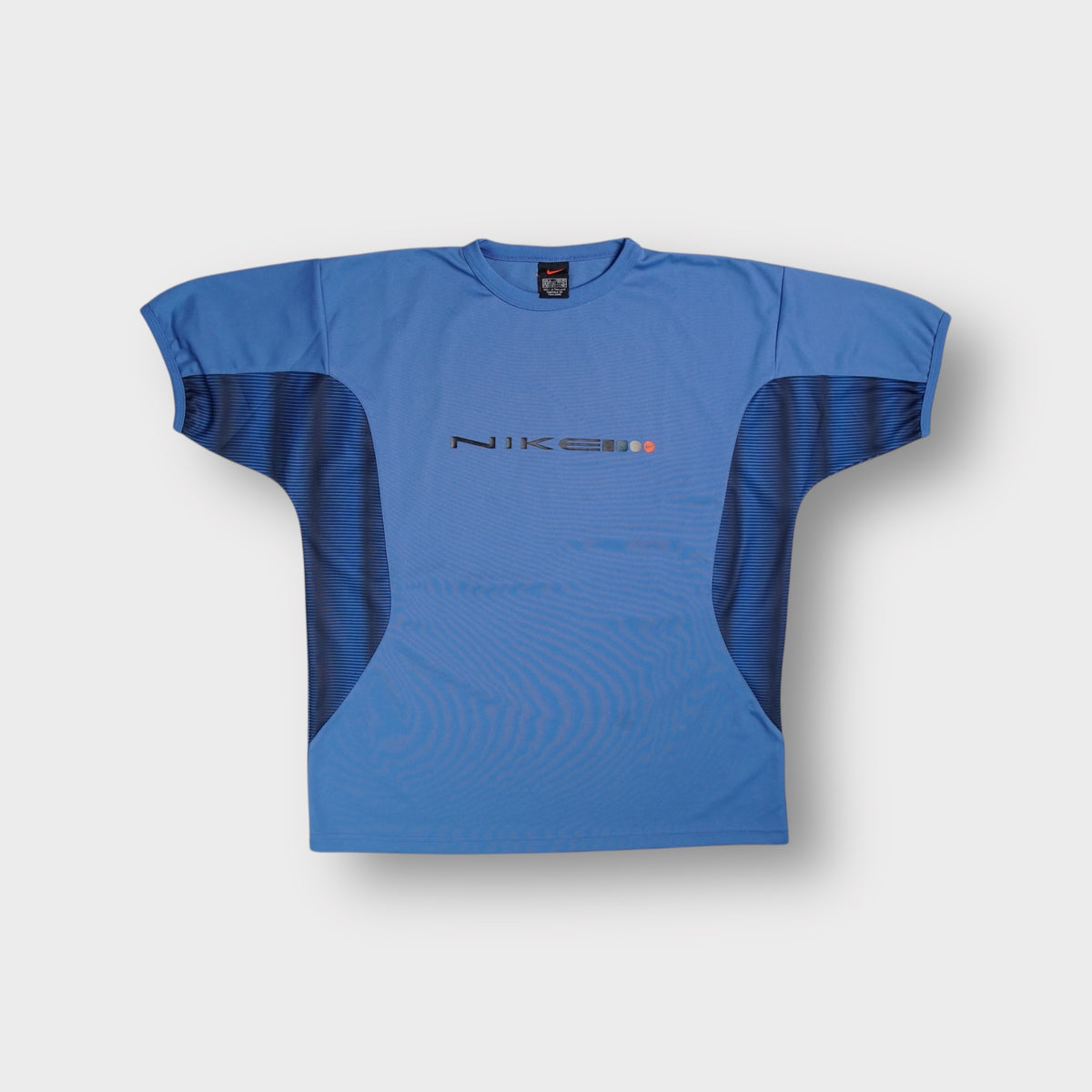 Nike short-sleeve shirt in blue with printed chest typography and dark side panels.