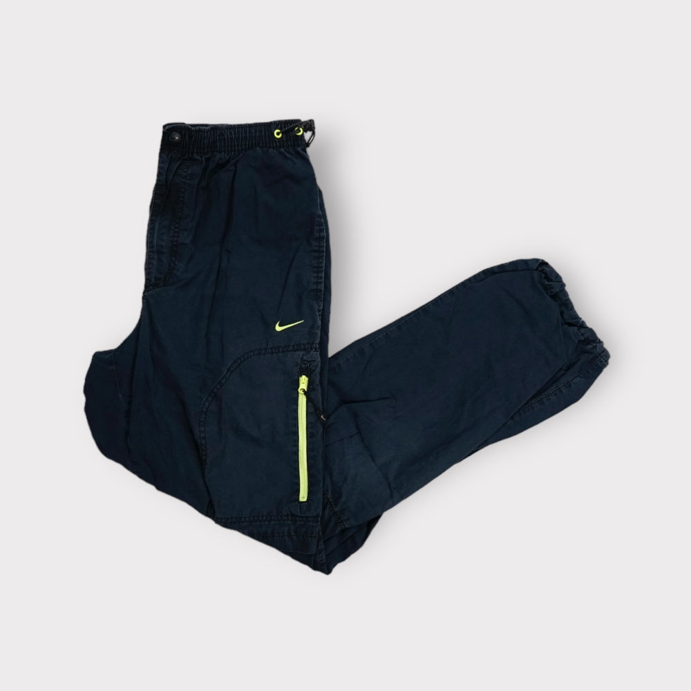 Nike black trackpants featuring a neon green zipper pocket and embroidered swoosh