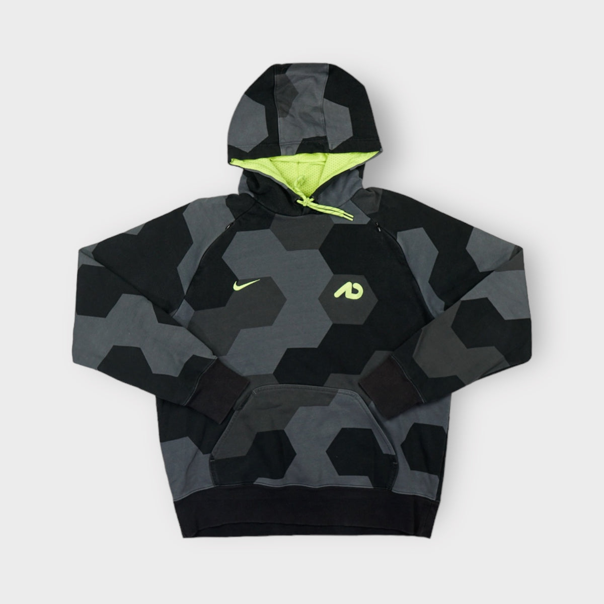Nike grey pullover hoodie featuring a geometric pattern and neon yellow hood lining