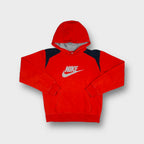 Nike pullover hoodie in red featuring a printed grey swoosh logo and contrasting shoulders