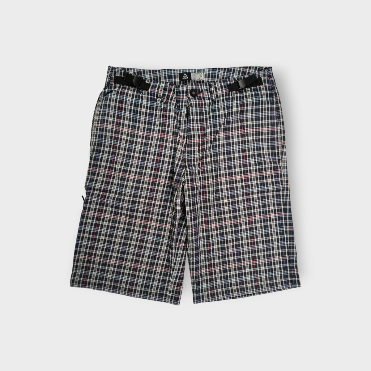 Nike ACG plaid shorts in white and dark pattern with integrated waist straps