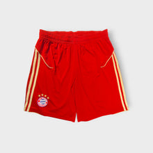 Load image into Gallery viewer, Red Adidas FC Bayern football shorts with embroidered club crest and gold stripes