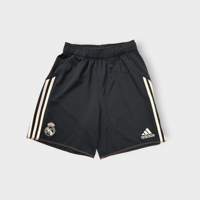 Adidas Real Madrid black sports shorts featuring three white stripes and club crest