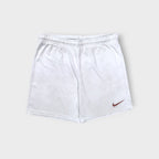 Nike white sports shorts with a swoosh logo on the leg and elastic drawstring waist