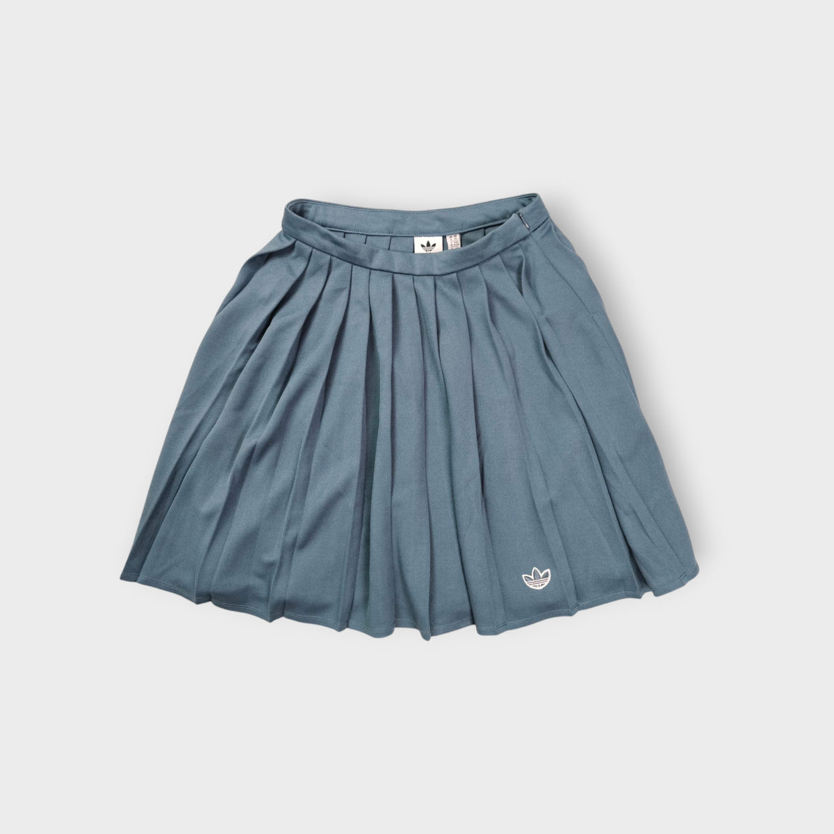 Adidas grey pleated skirt featuring an embroidered Trefoil logo near the hem