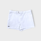 Lacoste shorts in white featuring an embroidered crocodile logo on the lower hem