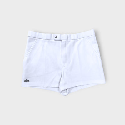 Lacoste shorts in white featuring an embroidered crocodile logo on the lower hem