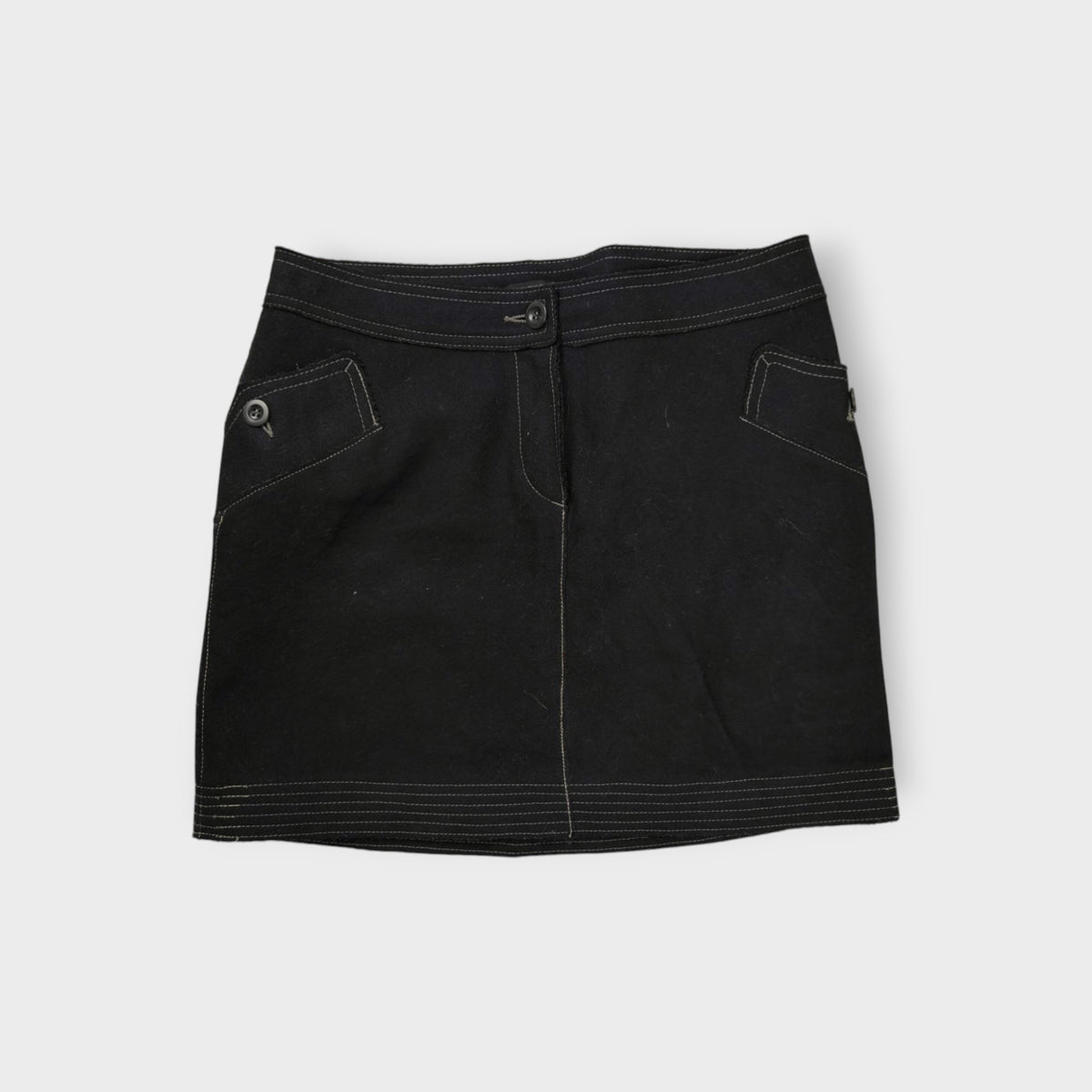 C.P. Company black wool skirt featuring contrast stitching and button pockets